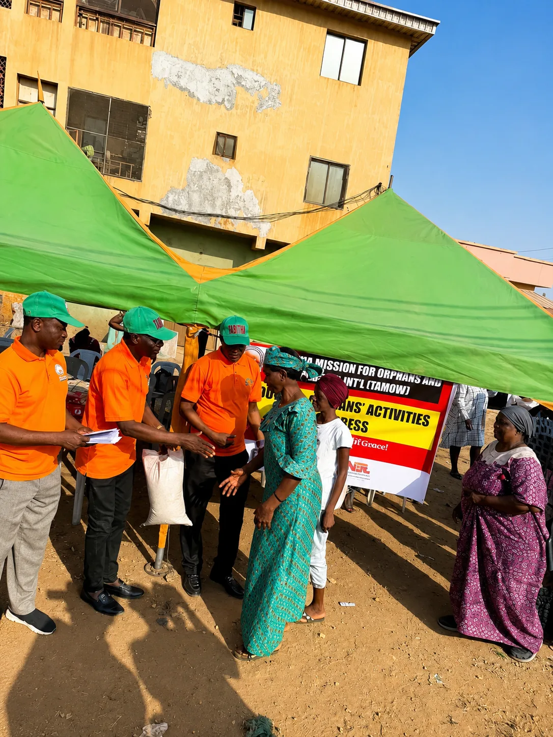 TAMOW team handing welfare support to a family