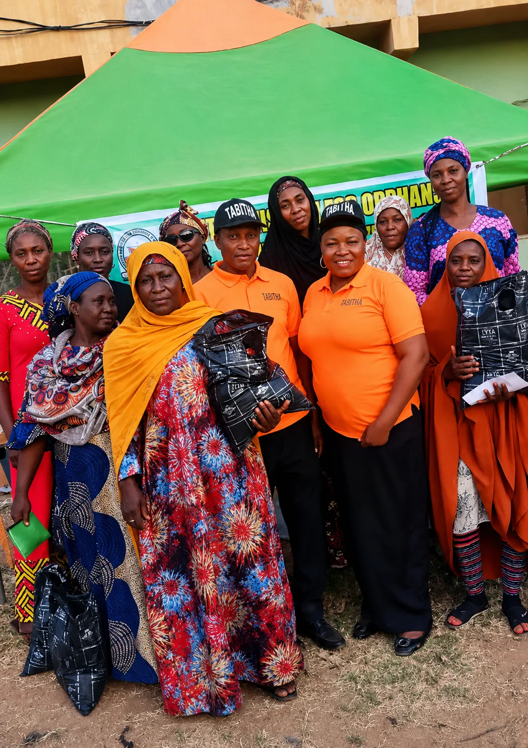 Group photo of TAMOW team with beneficiaries and their donated items