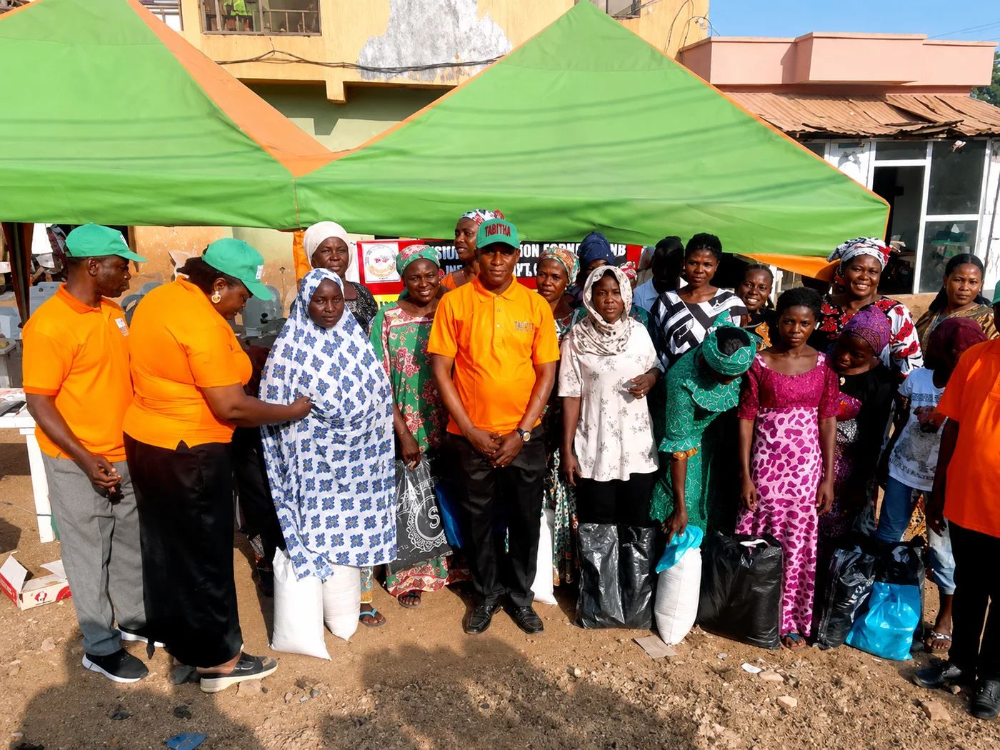 Group photo with widows and their relief packages