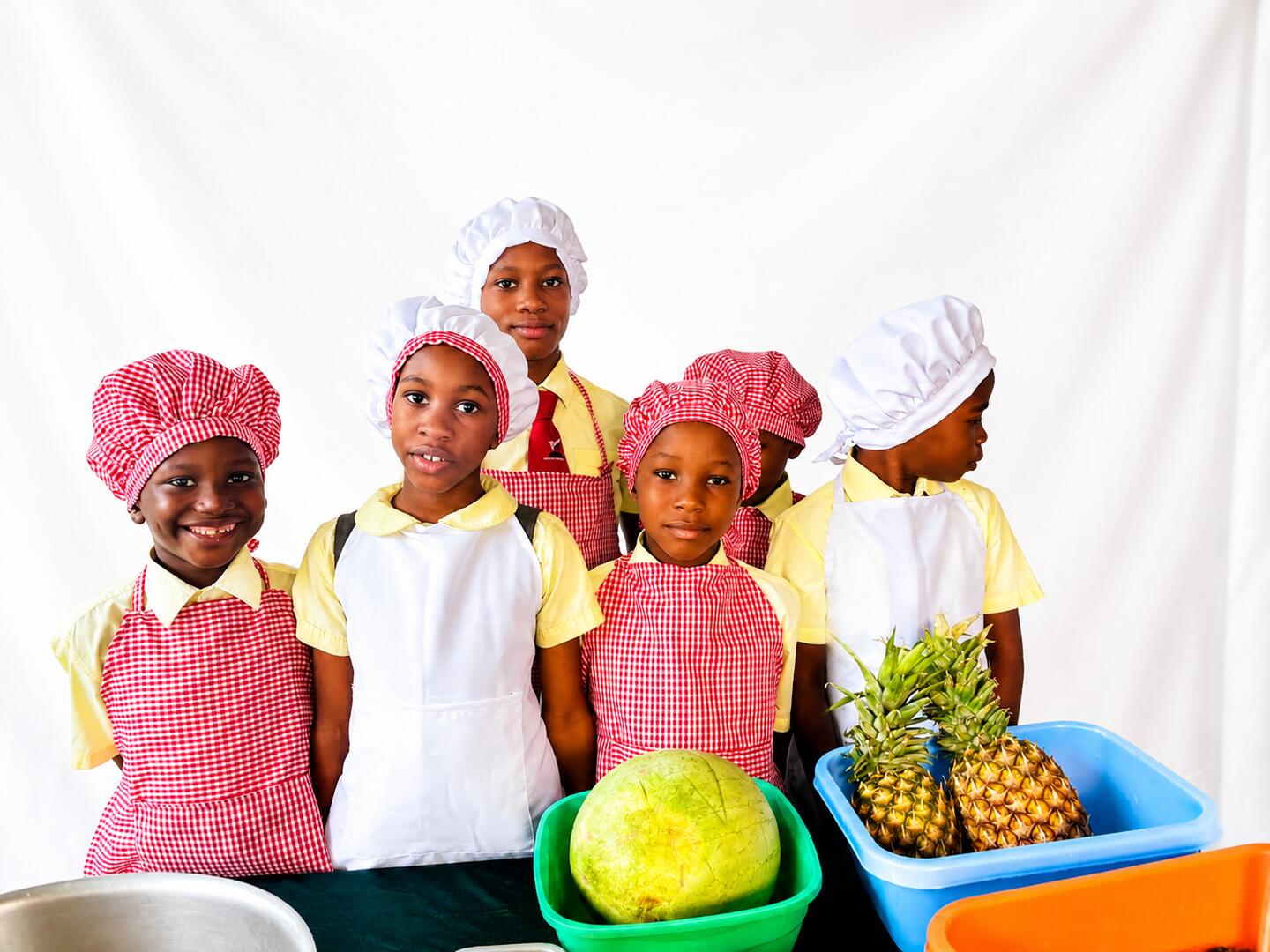 Pupils preparing fruit and juice in a cooking class