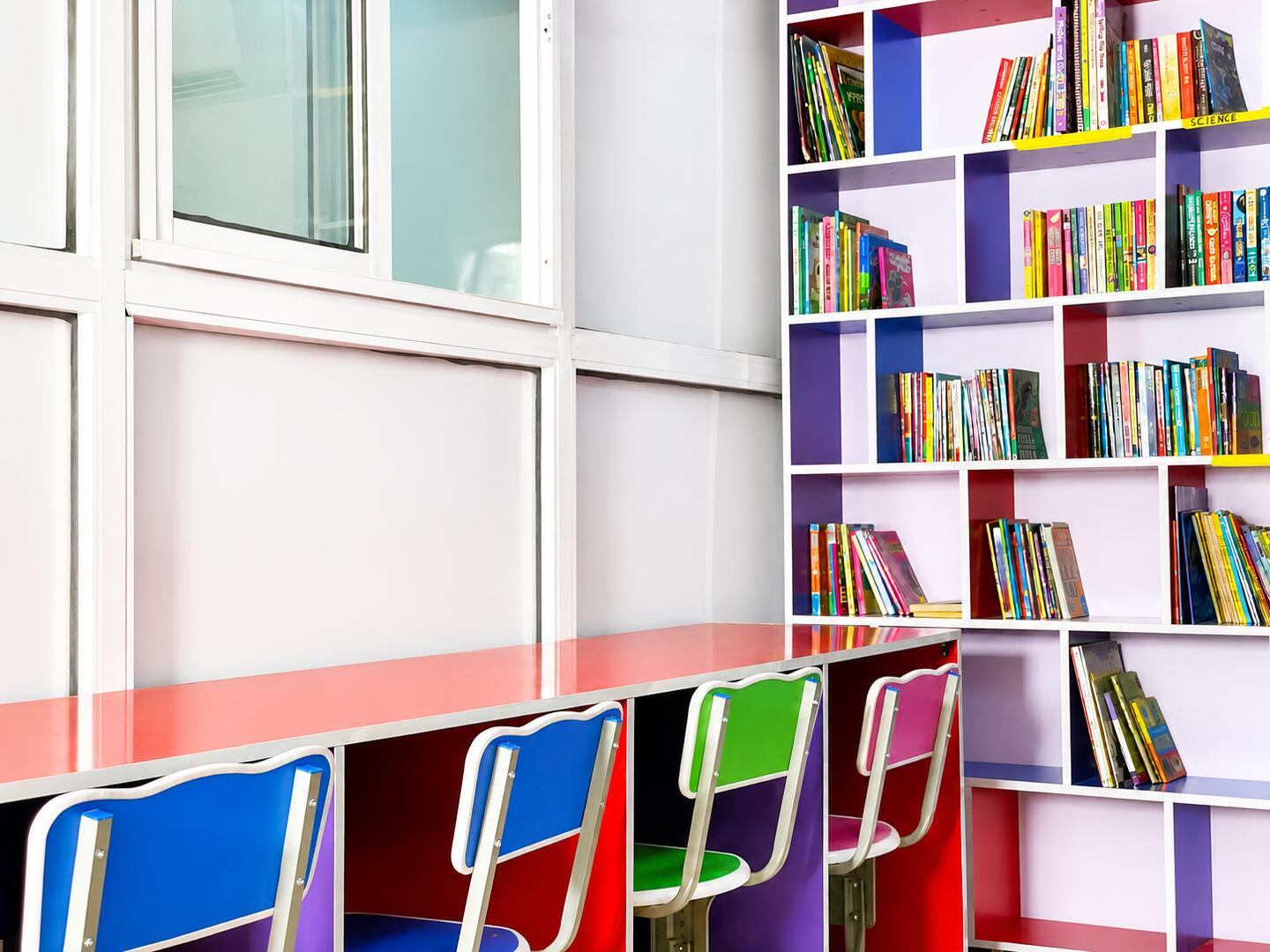 Colourful bookshelves and chairs in the library