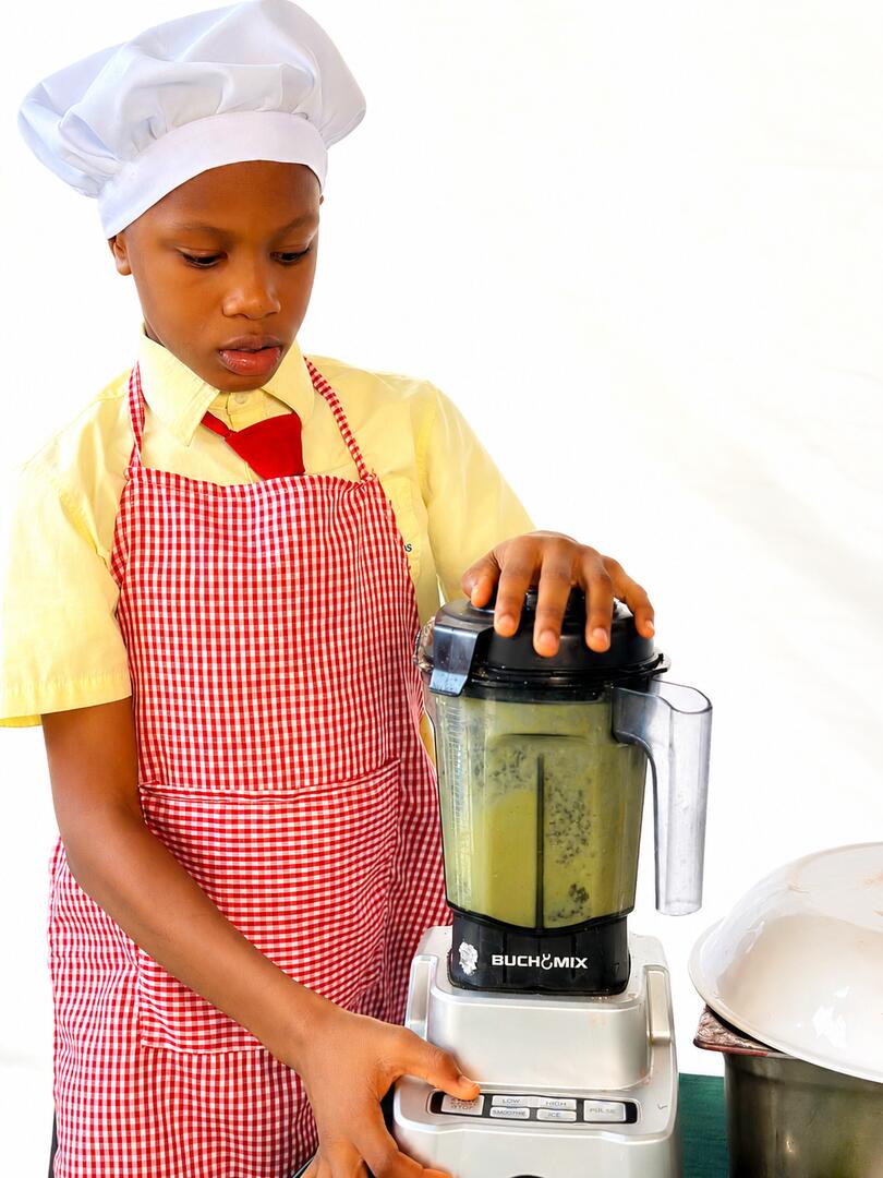 A pupil using a blender in a practical skills class