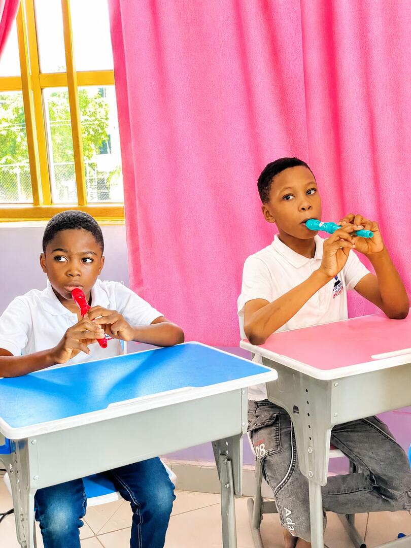 Pupils learning to play recorders in music class